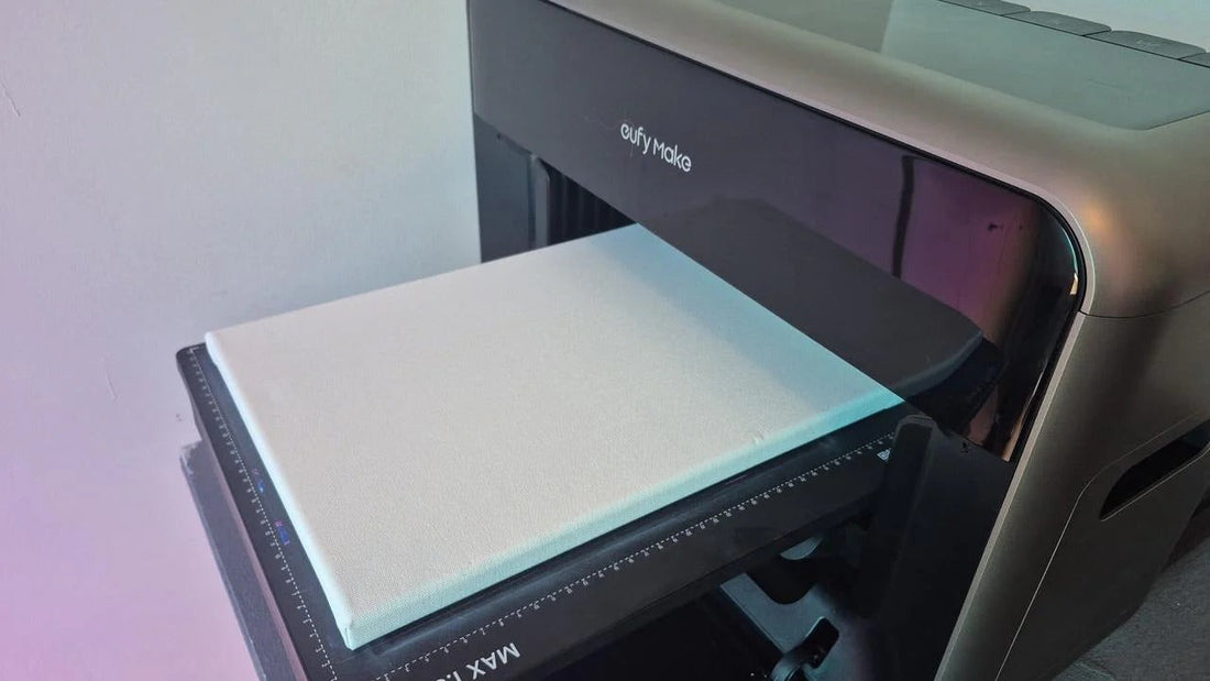 A blank white canvas positioned on the eufyMake E1 UV printer bed, ready for printing.